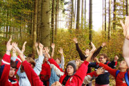 Gruppe Kinder wirft die Arme in die Luft